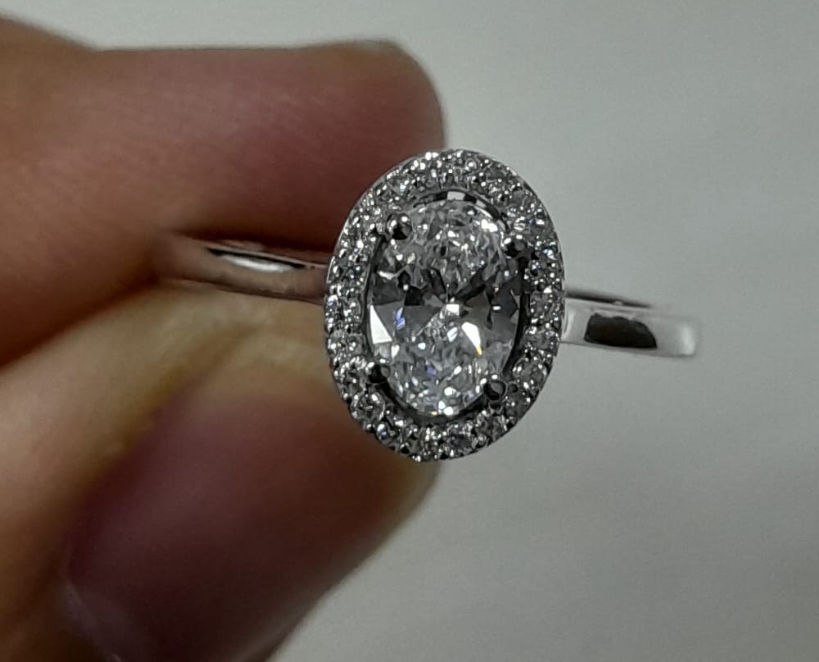 0.56 Carat Oval cut Lab Diamond in 18K WG ring