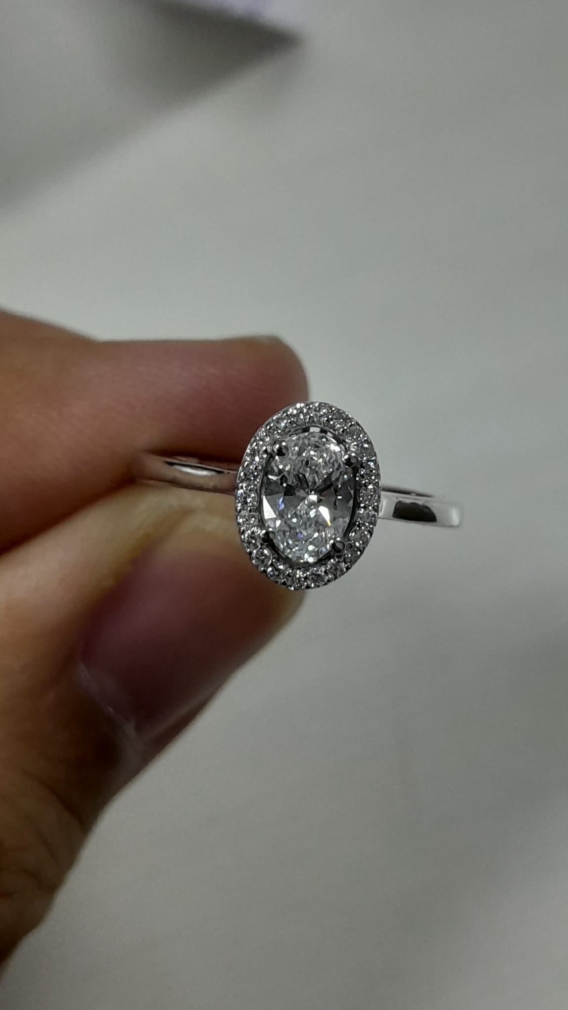 0.56 Carat Oval cut Lab Diamond in 18K WG ring